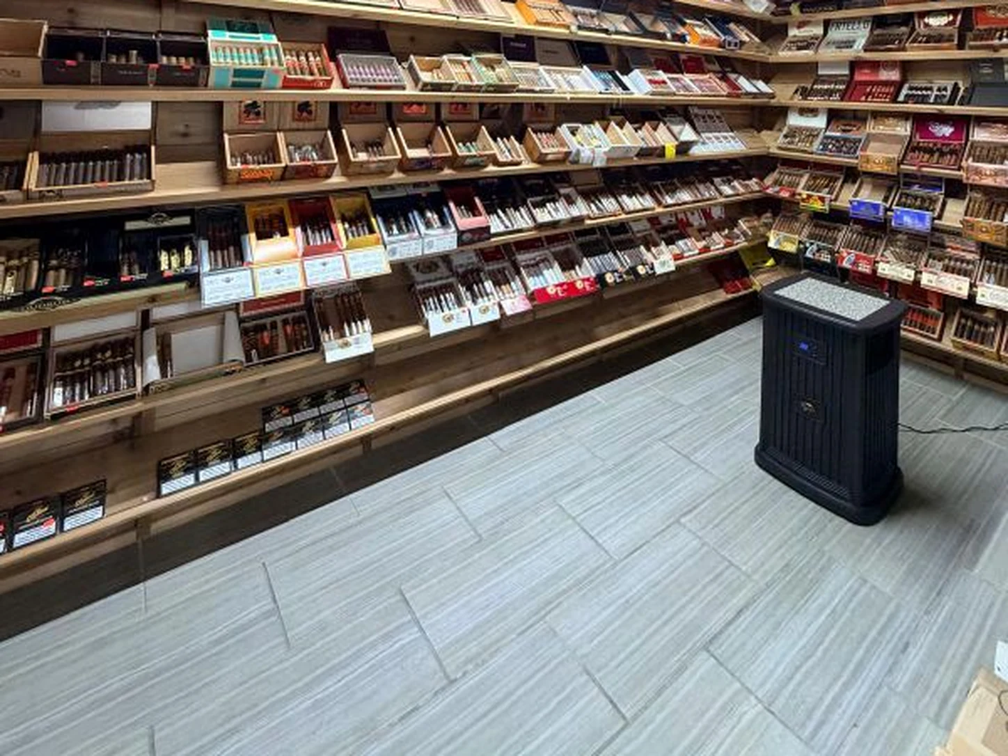 Cigar and humidor shelving with a seating nook at Midwest Smoke Shop on Dodge Street