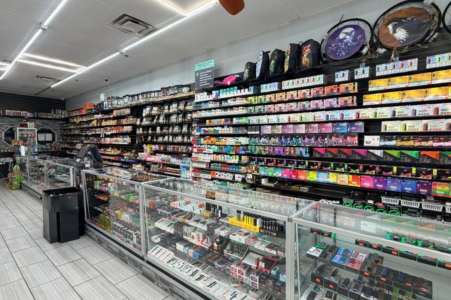 Cigarette, tobacco tin, and nicotine pouch wall at Midwest Smoke Shop on Dodge Street