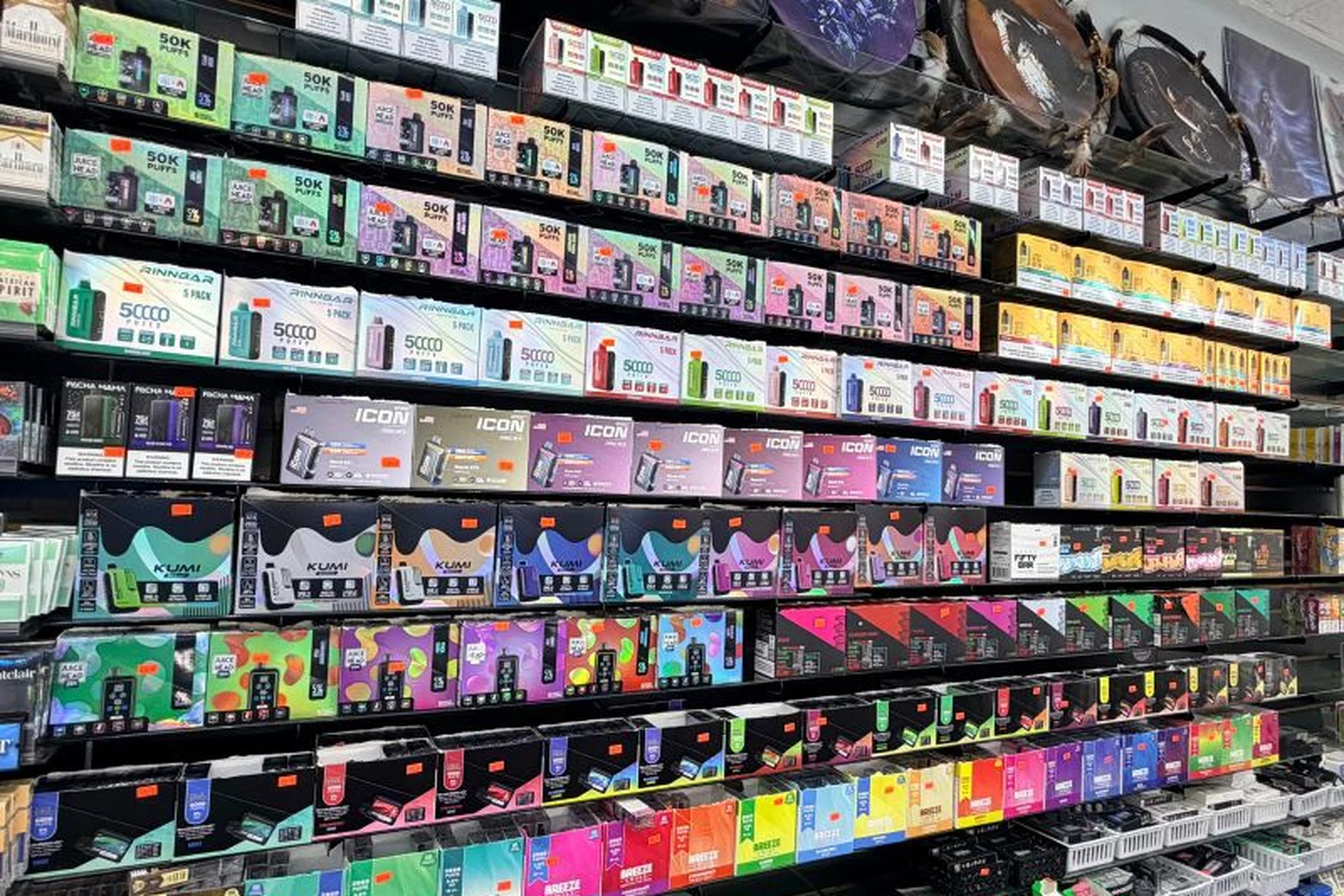 Wall of disposable vapes and e-liquids at Midwest Smoke Shop on Dodge Street